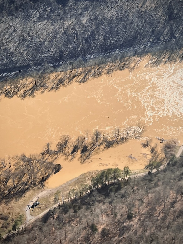 A Kentucky Army National Guard UH-60 Black Hawk lands in eastern Kentucky to check on a small boat going upstream while aiding in search efforts for stranded flood survivors on February 17, 2025.