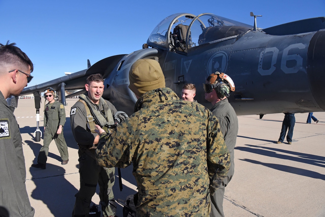An aircraft pilot gets out of an airplane.