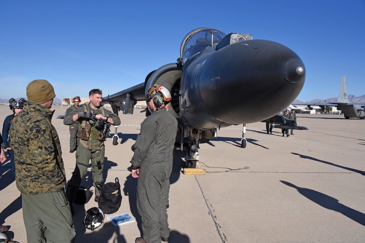 An aircraft pilot gets out of an airplane.