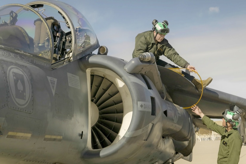 Marines removes military markings from an aircraft.