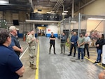 Employees receive awards in warehouse.