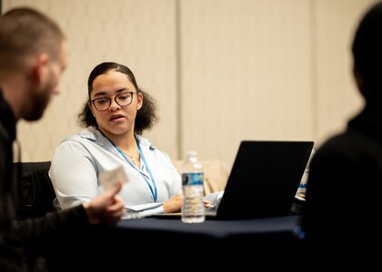 Kalyse Eckert, a contractor with Military Sealift Command (MSC), speaks with job seekers during Seafarers Day hosted by MSC at the Waterside Marriott in Norfolk Va. February 12, 2025. During the event, MSC personnel provided insights and shared career opportunities with attendees, helping them explore potential career paths.