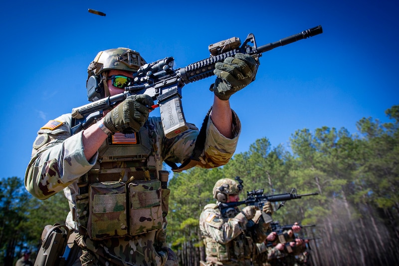 Two soldiers aiming down range