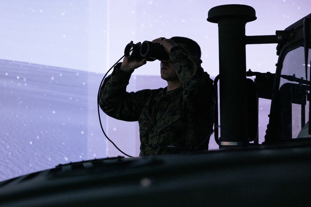 U.S. Marine Corps Staff Sgt. Tyler Jackson, a battery local security chief with Battalion Landing Team 3/6, 22nd Marine Expeditionary Unit, searches for threats during a combat convoy simulator as part of an Explosive Hazards Improvised Threat (EHIT) Basic Leaders Course at Marine Corps Base Camp Lejeune, North Carolina, Feb. 6, 2025. The EHIT Basic Leaders Course is a unique training that teaches Marines how to handle explosive hazards and improvised threats, build skills, teach others, and stay ready for dangerous environments. (U.S. Marine Corps photo by Cpl. Maurion Moore)