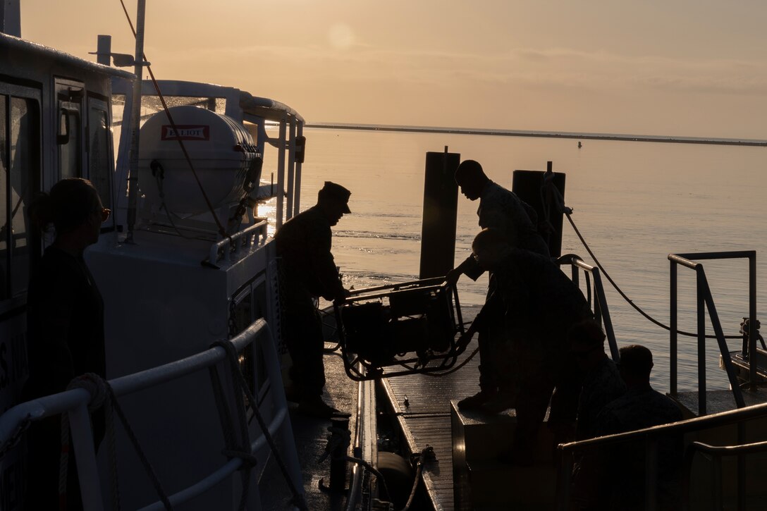 U.S. Marines with Marine Wing Support Squadron (MWSS) 272, load gear onto a surface vessel at the U.S. Navy Atlantic Undersea Test and Evaluation Center on Andros Island, Bahamas, Feb. 20, 2025. MWSS-272 deployed to the Bahamas to conduct aviation ground support rehearsals and refine distributed aviation operations for 2nd Marine Aircraft Wing. (U.S. Marine Corps photo by Lance Cpl. Mya Seymour)