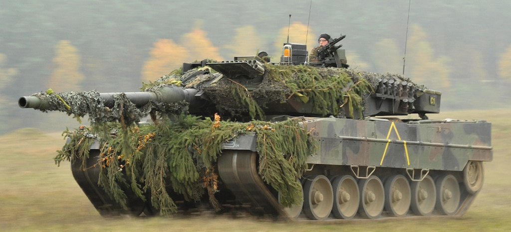 A German Army Leopard II tank, assigned to 104th Panzer Battalion, moves through the Joint Multinational Readiness Center during Saber Junction 2012  in Hohenfels, Germany, Oct. 25. The U.S. Army Europe's exercise Saber Junction trains U.S. personnel and 1800 multinational partners from 18 nations ensuring multinational interoperability and an agile, ready coalition force.