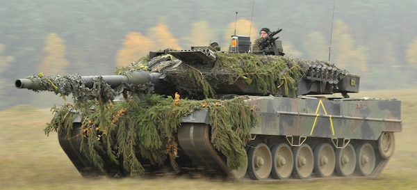 A German Army Leopard II tank, assigned to 104th Panzer Battalion, moves through the Joint Multinational Readiness Center during Saber Junction 2012  in Hohenfels, Germany, Oct. 25. The U.S. Army Europe's exercise Saber Junction trains U.S. personnel and 1800 multinational partners from 18 nations ensuring multinational interoperability and an agile, ready coalition force.