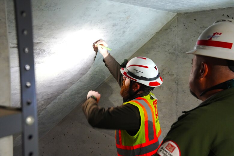 A.Y. York, civil engineer with the U.S. Army Corps of Engineers Nashville District, marks an area of the wall inside the dam during a special dam inspection of Martins Fork Dam in Smith, Kentucky on Feb. 25, 2025. The inspection, which found no significant structural concerns, was required after Martins Fork reservoir set a new record for pool elevation after heavy rains passed through the region.