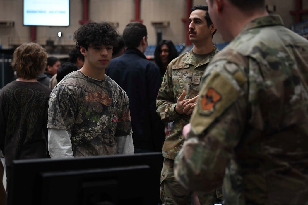 U.S. Air Force service members speak with a local high school student at the SPARK Youth Career Expo, Foster Communication Coliseum, San Angelo, Feb. 26, 2025. Goodfellow Air Force Base’s Airmen played a key role in demonstrating the diverse career fields available in the U.S. Air Force, from intelligence and firefighting to cyber operations and public affairs. (U.S. Air Force photo by Senior Airman Madi Collier)