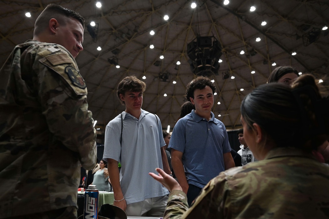 U.S. Air Force service members speak with a local high school student at the SPARK Youth Career Expo, Foster Communication Coliseum, San Angelo, Feb. 26, 2025. Goodfellow Air Force Base’s Airmen played a key role in demonstrating the diverse career fields available in the U.S. Air Force, from intelligence and firefighting to cyber operations and public affairs. (U.S. Air Force photo by Senior Airman Madi Collier)