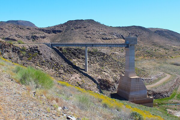 The U.S. Army Corps of Engineers Los Angeles District’s Painted Rock Dam is pictured March 2024 near Gila Bend, Arizona. Most of the year, the reservoir remains dry; however, the last two years have seen an increase of waterflow, potentially raising the risk to the dam’s drainage area of 50,800 square miles. According to USACE records, Painted Rock Dam was built specifically to protect downstream agriculture, Yuma, and other towns and small businesses along the Gila River. (Photo by Robert DeDeaux, USACE Los Angeles District Public Affairs)