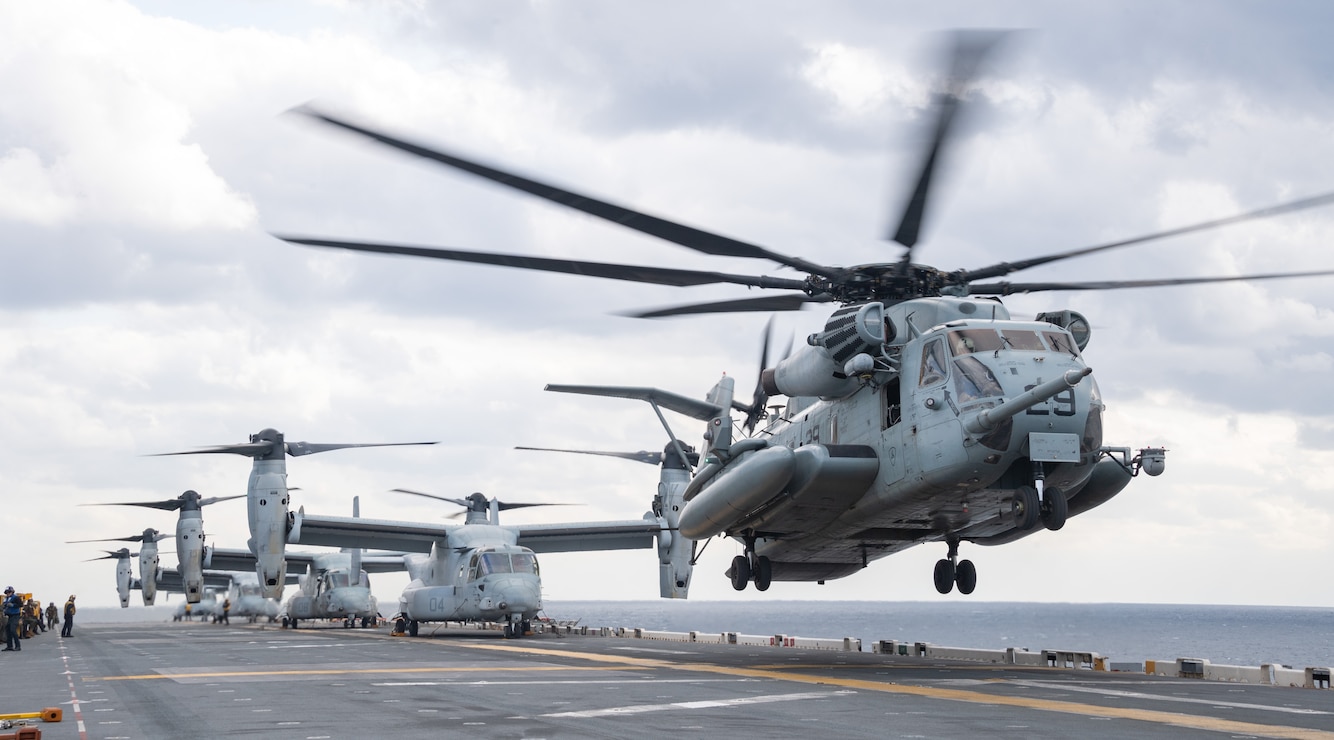 A CH-53E Super Stallion helicopter, from the 31st Marine Expeditionary Unit (MEU) Air Combat Element (ACE) takes off from the flight deck of forward-deployed amphibious assault ship USS America (LHA 6) while conducting flight operations in the Philippine Sea, Feb. 18.