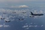 Japan Air Self-Defense Force, Royal Australian Air Force, and U.S. 4th and 5th generation aircraft fly in formation over the Pacific Ocean during exercise Cope North 25, Feb. 7, 2025. The aircraft in the photo are, from left to right: a U.S. Navy E/A-18 Growler, U.S. Marine Corps F/A-18C Hornet, U.S. Air Force F-16CM, U.S. Marine Corps F-35B Lightning II, Royal Australian Air Force F-35A Lightning II, JASDF F-35A Lightning II, U.S. Air Force F-35A Lightning II, and JASDF KC-747. Japanese, Australian, and U.S. air forces trained together during CN25 to streamline combined tactics and, if needed, win in an armed conflict. (U.S. Marine Corps photo by Cpl. Chloe Johnson)