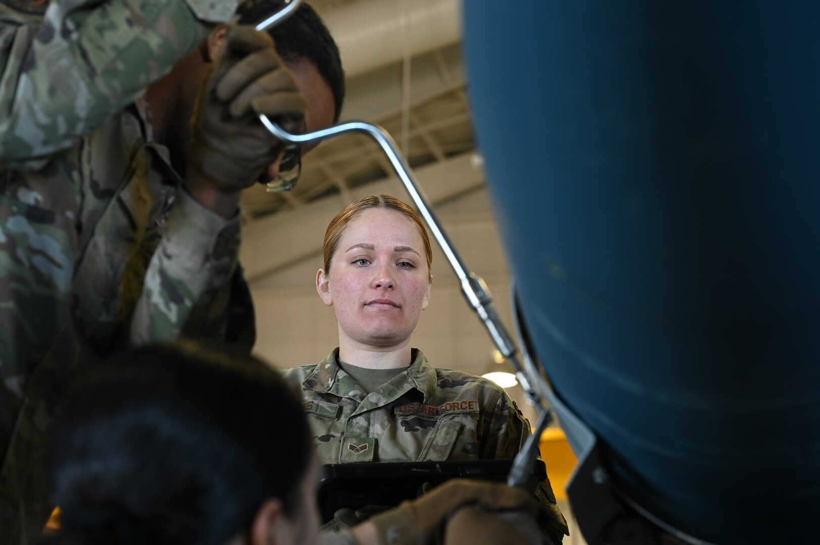 U.S. Air Force Senior Airman Jordan Bates, 509th Munitions Squadron, conventional maintenance crew chief, supervises Airmen working on a conventional weapon at Whiteman Air Force Base, Missouri, March 17, 2023.