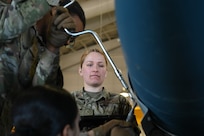 U.S. Air Force Senior Airman Jordan Bates, 509th Munitions Squadron, conventional maintenance crew chief, supervises Airmen working on a conventional weapon at Whiteman Air Force Base, Missouri, March 17, 2023.