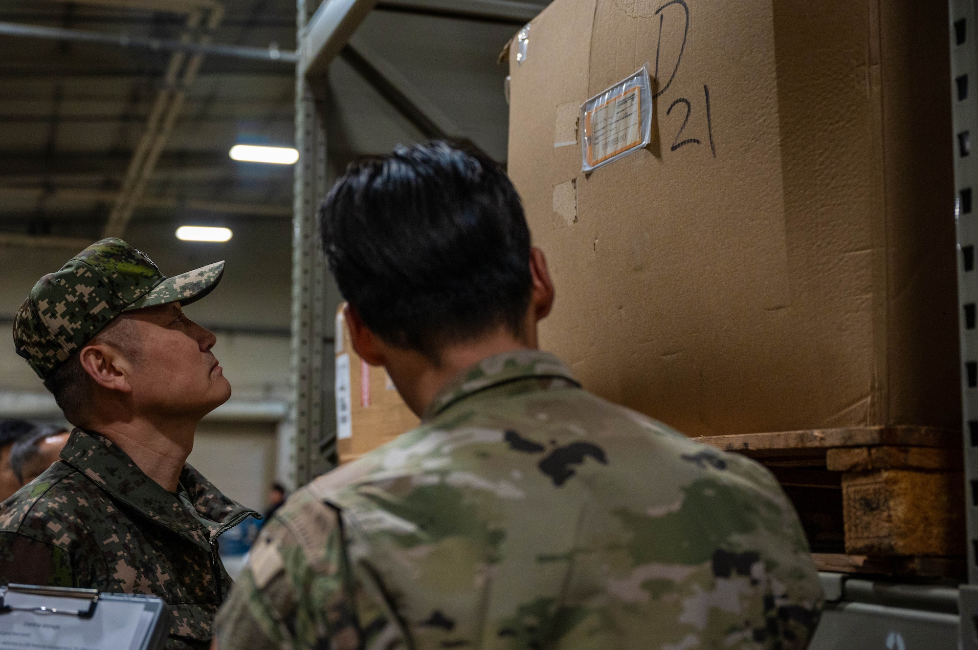 Republic of Korea Army Brig. Gen. Jung Hwan Lee, Combined Forces Command C4 director, left, checks a supply box during a tour of the 51st Logistics Readiness Squadron at Osan Air Base, ROK, Feb. 26, 2025. Lee and his team also visited the 36th Fighter Generation Squadron to learn more about F-16 Fighting Falcon capabilities. (U.S. Air Force photo by Staff Sgt. Christopher Tam)