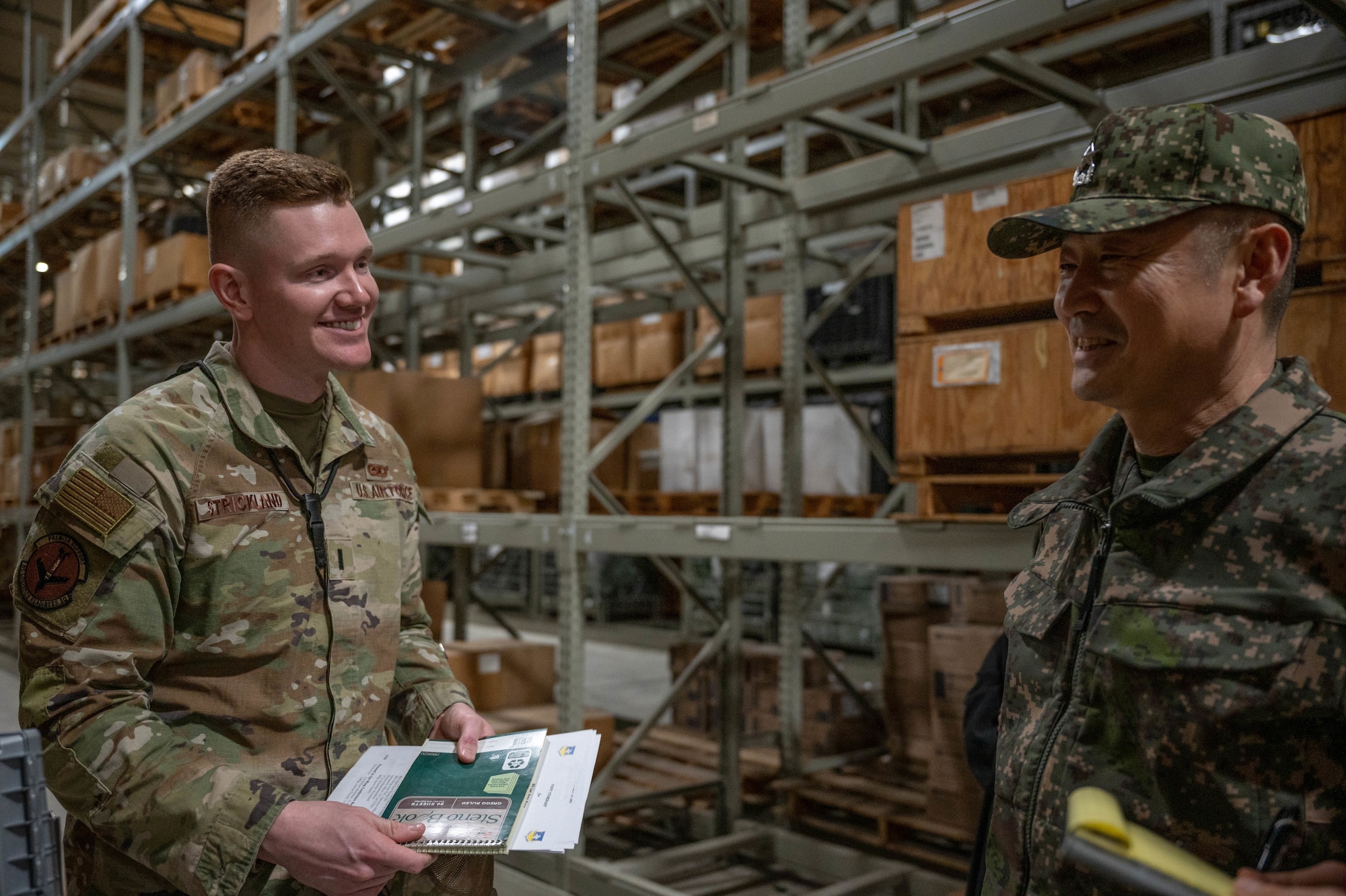 U.S Air Force 1st Lt. Alexander Strickland, 51st Logistics Readiness Squadron material management flight commander, left, engages with Republic of Korea Army Brig. Gen. Jung Hwan Lee, Combined Forces Command C4 director at Osan Air Base, ROK, Feb. 26, 2025. Lee’s visit to Osan strengthened ties with the 51st Fighter Wing and enhanced coordination with CFC operations. (U.S. Air Force photo by Staff Sgt. Christopher Tam)
