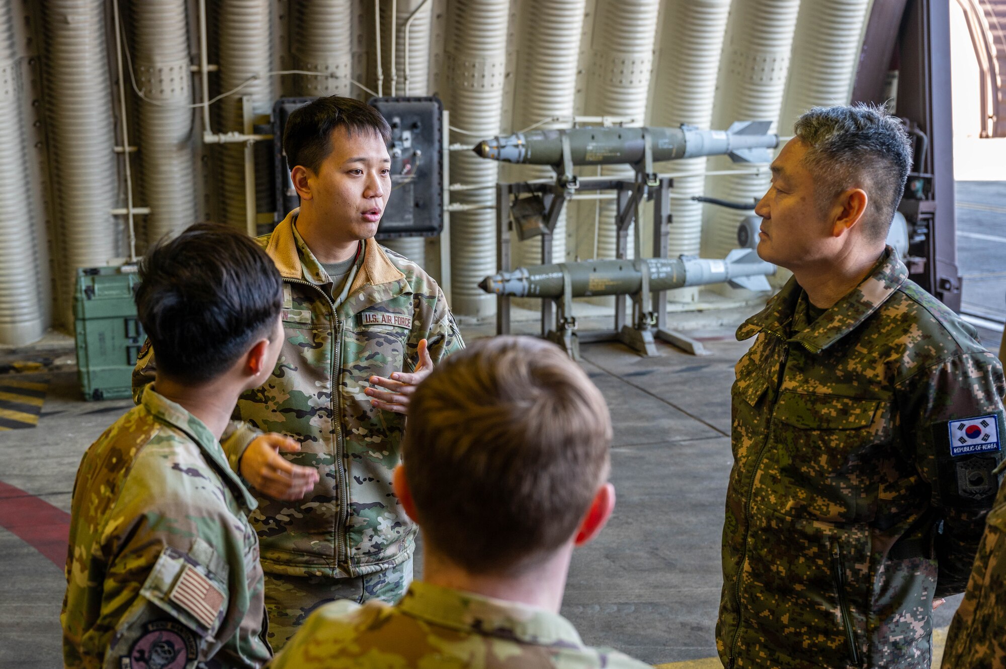 U.S. Air Force Capt. Michael Shin, 36th Fighter Generation Squadron sortie generation flight commander, briefs Republic of Korea Army Brig. Gen. Jung Hwan Lee, Combined Forces Command C4 director at Osan Air Base, ROK, Feb. 26, 2025. Lee and his team visited the 36 FGS to review F-16 weapons systems and discuss the role of “Fight Tonight” hangars in readiness operations. (U.S. Air Force photo by Staff Sgt. Christopher Tam)