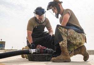 U.S. Air Force Col. Paul Sheets, 380th Air Expeditionary Wing commander, and Senior Airman Christian Scott, 380th Expeditionary Logistics Readiness Squadron petroleum, oil and lubricants fuels distribution operator, check for hose malfunctions within the U.S. Central Command area of responsibility, Feb. 25, 2025. Wing leadership's visit was an opportunity for a hands-on experience of POL’s refueling procedures, safety protocols and equipment handling. (U.S. Air Force photo by Senior Airman Sir Wyrick)