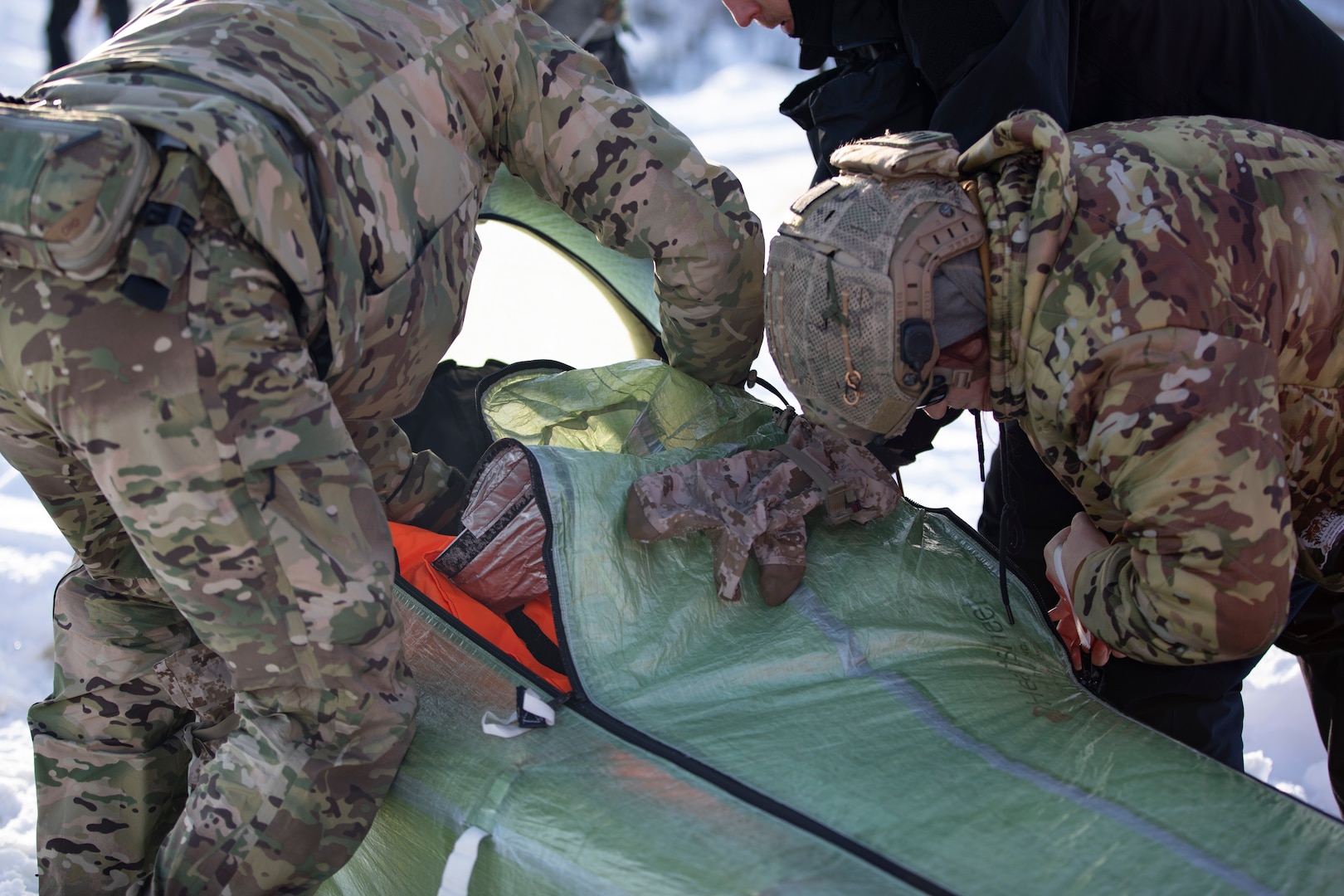 Exercise Special Operations Forces Arctic Medic 2025 participants load a simulated combat casualty into a CASEVAC Ecosystem sled prototype at Yukon Training Area, Alaska, Feb. 18, 2025. SOFAM 2025 prepared its participants to conduct medical operations in extreme cold.