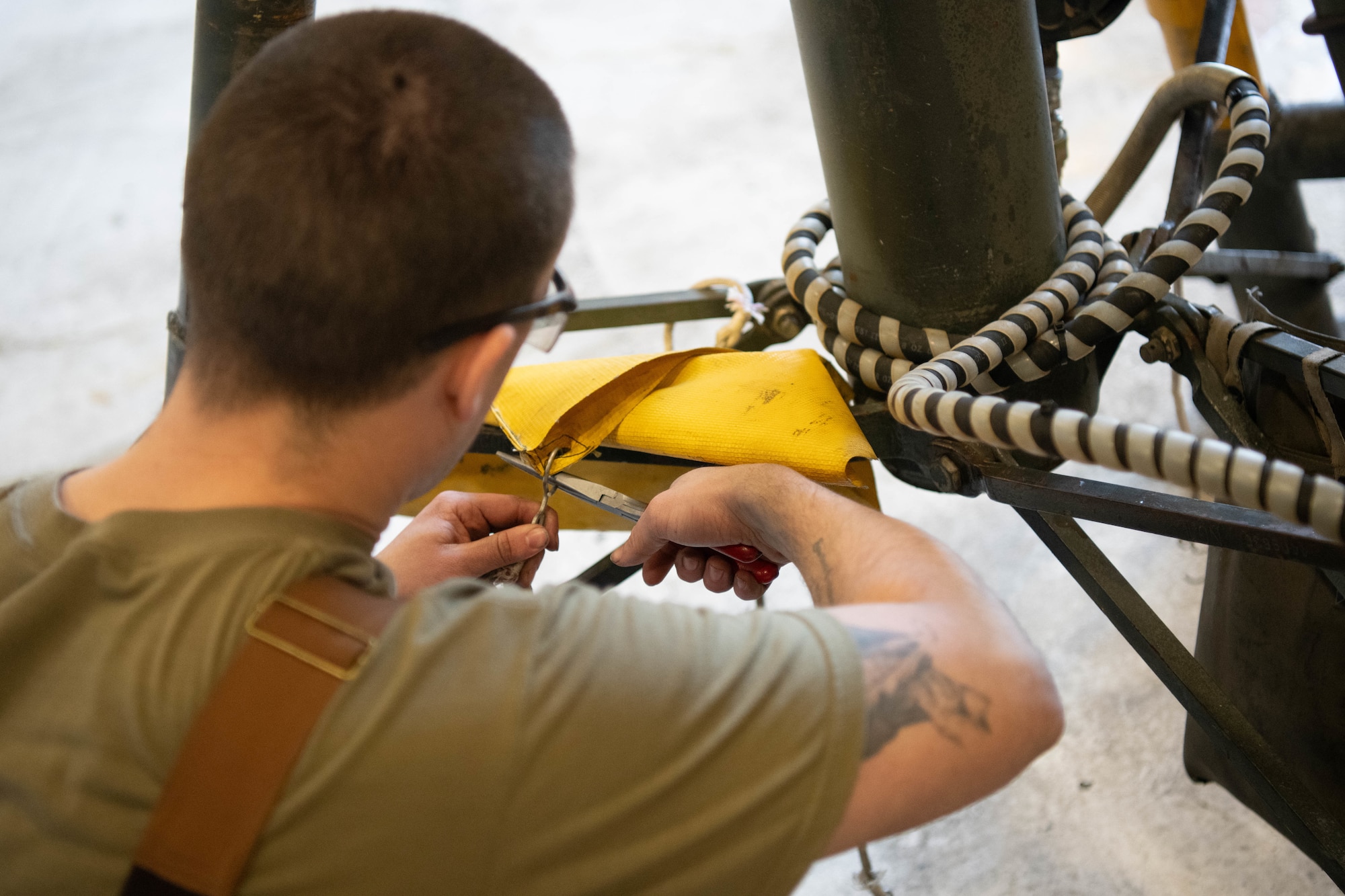 Staff Sgt. Kyle Wilson, 22nd Maintenance Squadron aerospace ground equipment technician, works on a tripod jack in the AGE shop at McConnell Air Force Base, Kansas, Feb. 25, 2025. The tripod jack is used to hoist heavy equipment for maintenance.