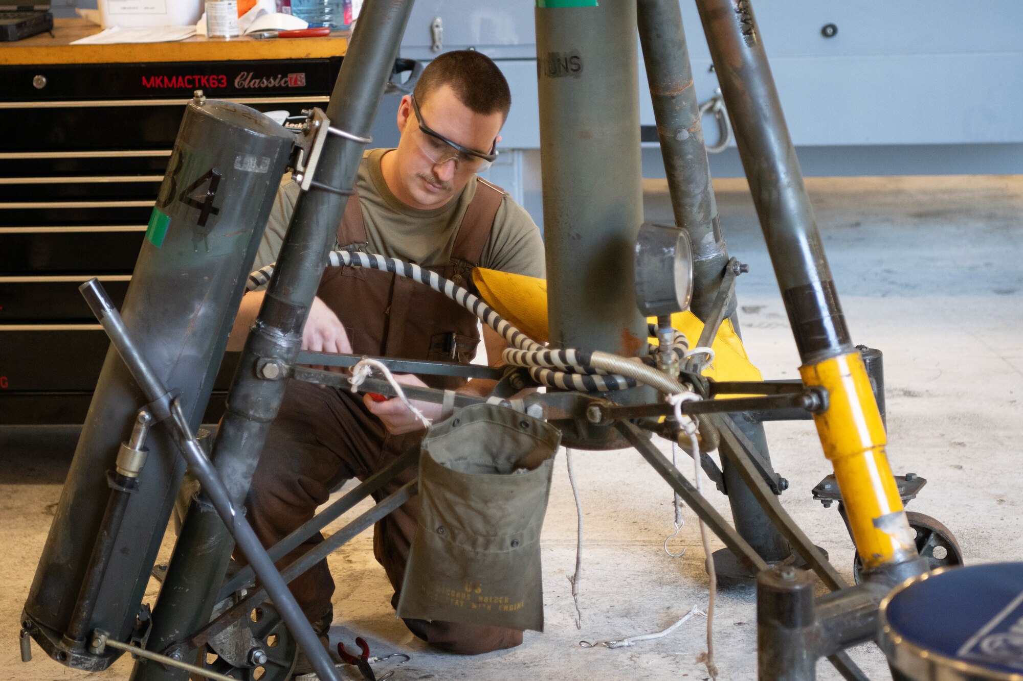 Staff Sgt. Kyle Wilson, 22nd Maintenance Squadron aerospace ground equipment technician, works on a tripod jack in the AGE shop at McConnell Air Force Base, Kansas, Feb. 25, 2025. The tripod jack is used to hoist heavy equipment for maintenance.