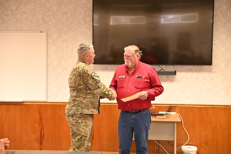 Col. Calvin Kroeger, the commander of the U.S. Army Corps of Engineers, Fort Worth District, presents a district belt buckle to Stanly “Easy” Frerich. Easy, who volunteers at Lake Georgetown, is the first lake volunteer to earn the coveted belt buckle. Col. Kroeger presented the belt buckle in recognition of Easy’s selection as the 2024 USACE Volunteer of the Year. In 2024 USACE had more than 37,900 volunteers across the command supporting natural resource management. In total, the volunteers served 1,751,141 hours, equivalent to 842 full-time employes. The total estimated value of volunteer hours is $58.6 million.