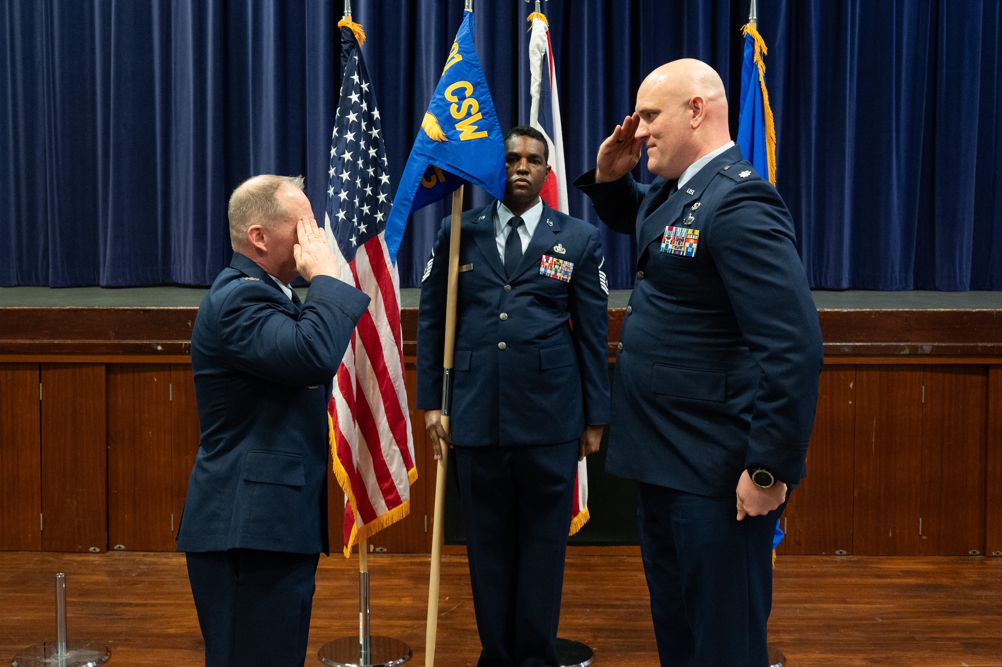 U.S. Air Force Col. D. Landon Phillips, 501st Combat Support Wing commander, left, salutes Lt. Col. Brian Erickson, 501st Combat Support Wing Comptroller Squadron commander, right, during the 501st CSW Comptroller Squadron stand-up ceremony