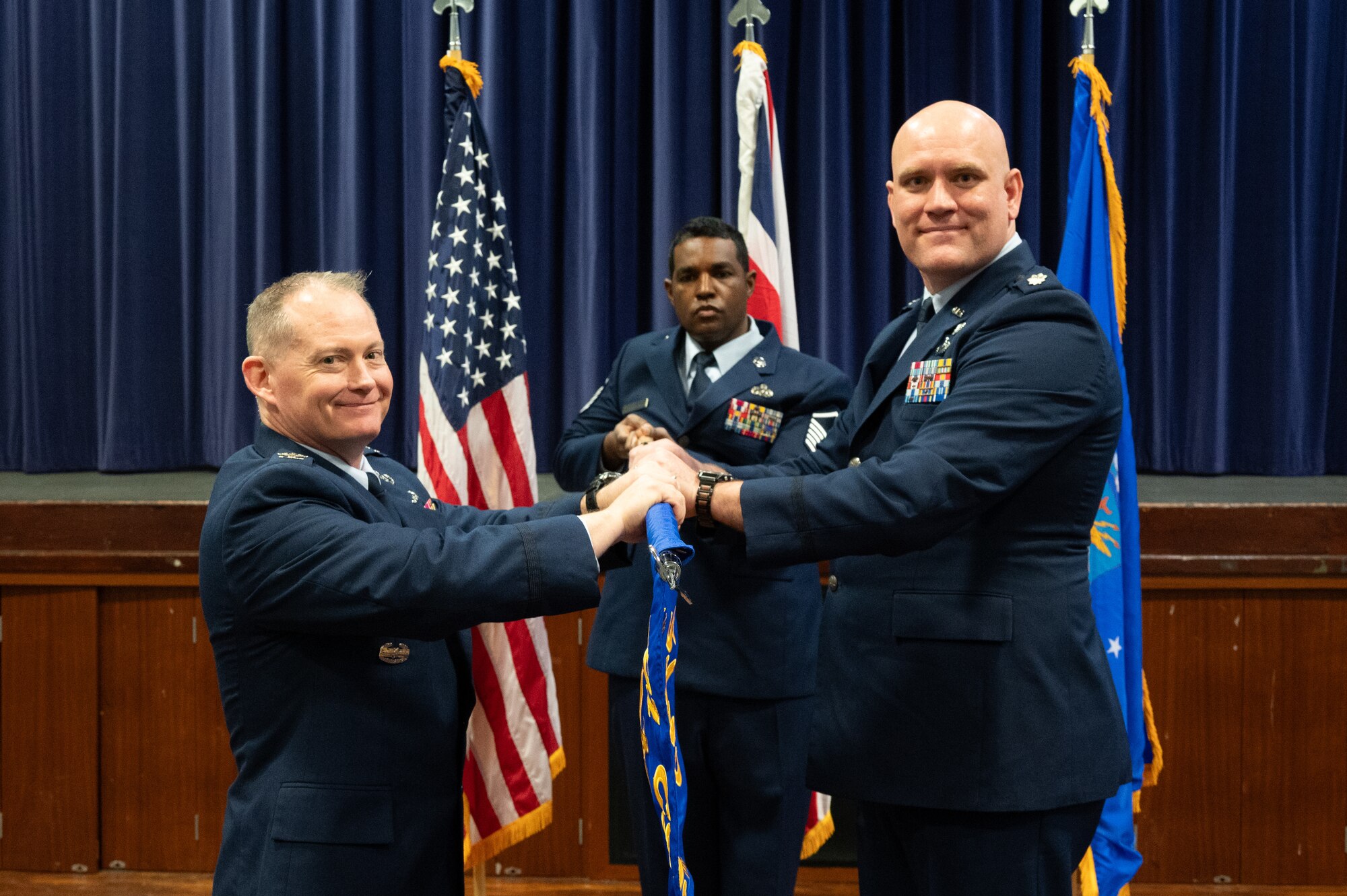U.S. Air Force Lt. Col. Brian Erickson, 501st Combat Support Wing Comptroller Squadron commander, right, accepts command