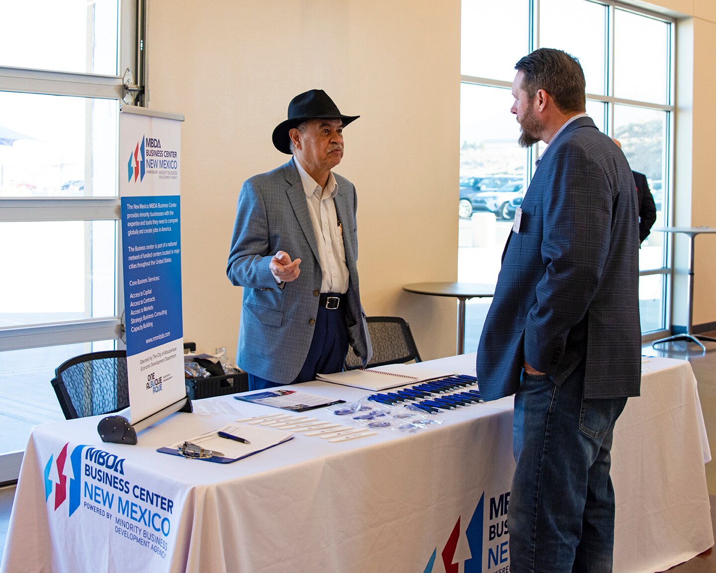 An attendee of the USACE-Albuquerque District’s Business Opportunities Open House speaks with a representative from the U.S. Chamber of Commerce Minority Business Development Agency, one of several other agencies that also participated in the event at the Sid Cutter Pilot’s Pavilion at the Balloon Fiesta Park in Albuquerque, N.M., Feb. 20, 2025.