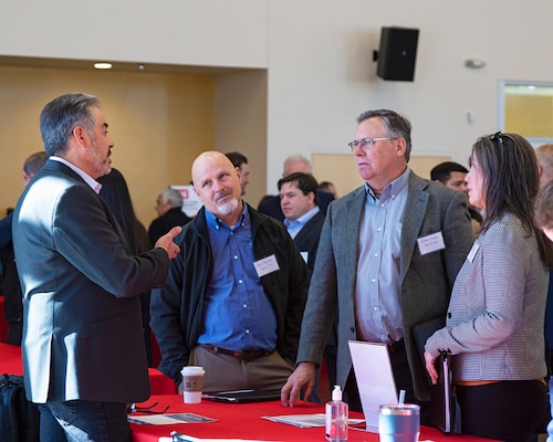 Chris Velasquez (left), design branch chief, USACE-Albuquerque District, describes the design decision-making process to attendees during the district’s Business Opportunities Open House at the Sid Cutter Pilot’s Pavilion at the Balloon Fiesta Park, Feb. 20, 2025.