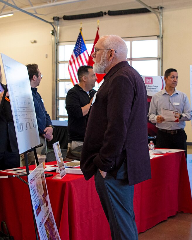 An attendee at the USACE-Albuquerque District’s Business Opportunities Open House looks at a chart showing some upcoming opportunities to work with the district during the open house at the Sid Cutter Pilot’s Pavilion at the Balloon Fiesta Park in Albuquerque, N.M., Feb. 20, 2025.