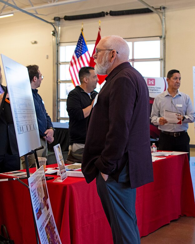 An attendee at the USACE-Albuquerque District’s Business Opportunities Open House looks at a chart showing some upcoming opportunities to work with the district during the open house at the Sid Cutter Pilot’s Pavilion at the Balloon Fiesta Park in Albuquerque, N.M., Feb. 20, 2025.