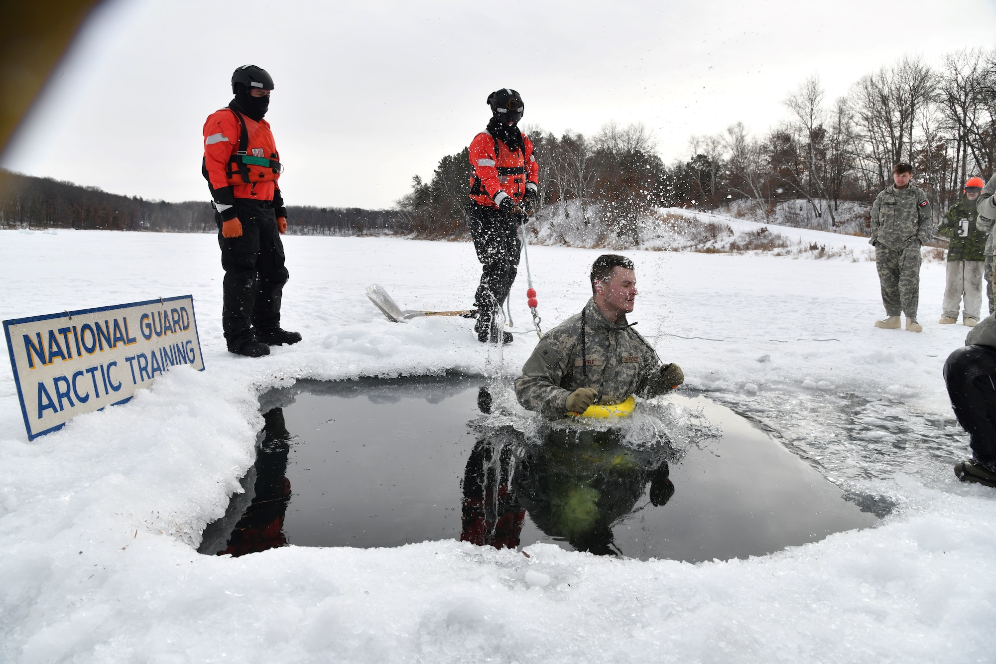 Photo of U.S. Air Force Tech. Sgt. Stephen Viele, a Security Forces Specialist assigned to the 158th Fighter Wing, Vermont Air National Guard, participating in cold-water immersion as part of the Air National Guard's cold weather operations course at Camp Ripley Training Center, Minn., Feb. 7, 2025.