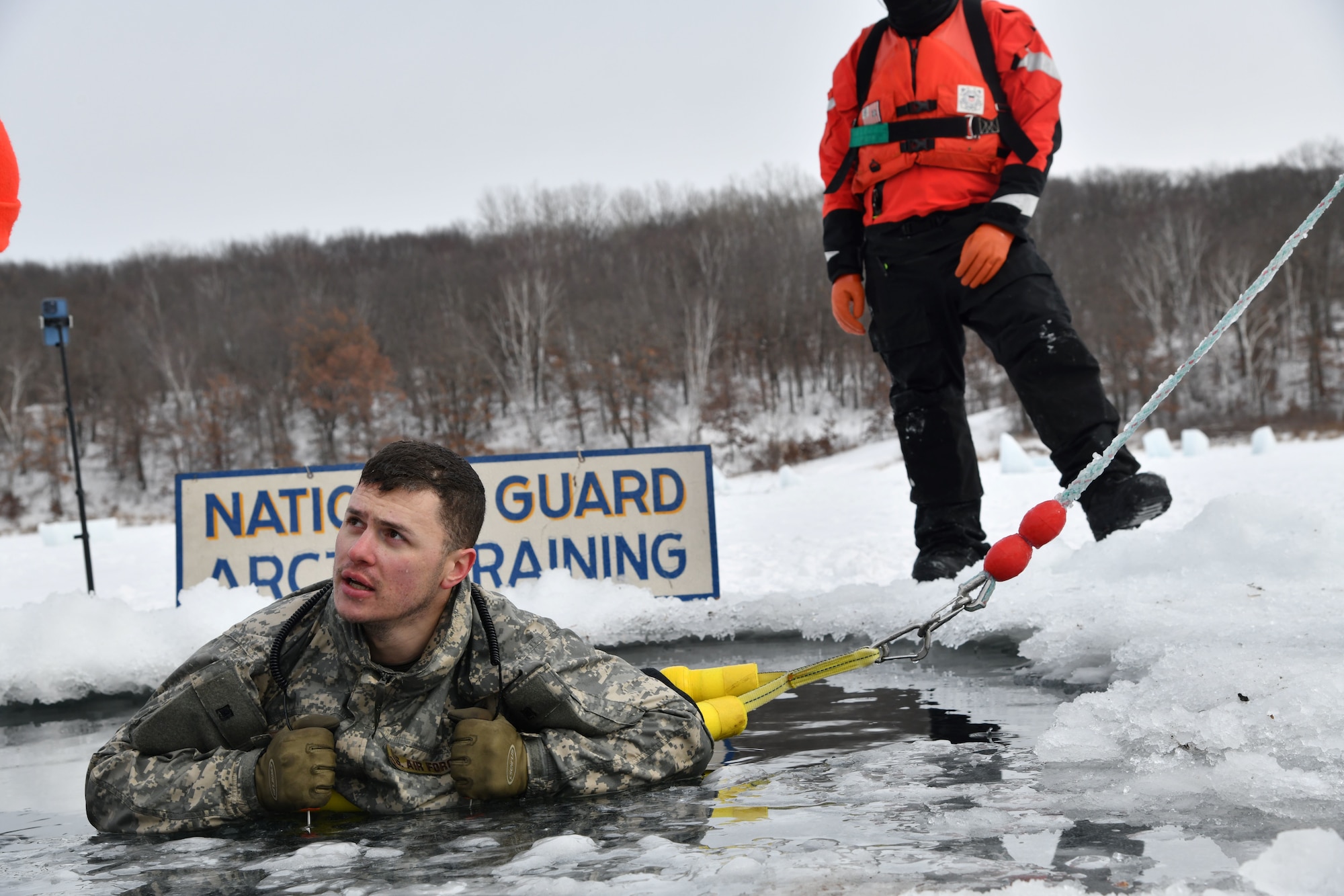Photo of U.S. Air Force Tech. Sgt. Stephen Viele, a Security Forces Specialist assigned to the 158th Fighter Wing, Vermont Air National Guard, participating in cold-water immersion as part of the Air National Guard's cold weather operations course at Camp Ripley Training Center, Minn., Feb. 7, 2025.