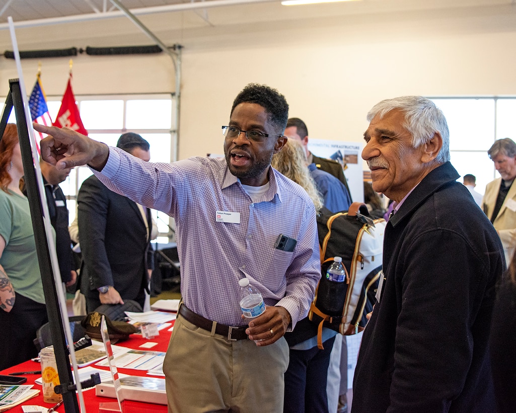 Felton Prosper (left), senior project manager, Civil Project Management Branch, USACE-Albuquerque District, shows upcoming business opportunities within the district to one of the attendees during the district’s Business Opportunities Open House at the Sid Cutter Pilot’s Pavilion at the Balloon Fiesta Park in Albuquerque, N.M., Feb. 20, 2025.