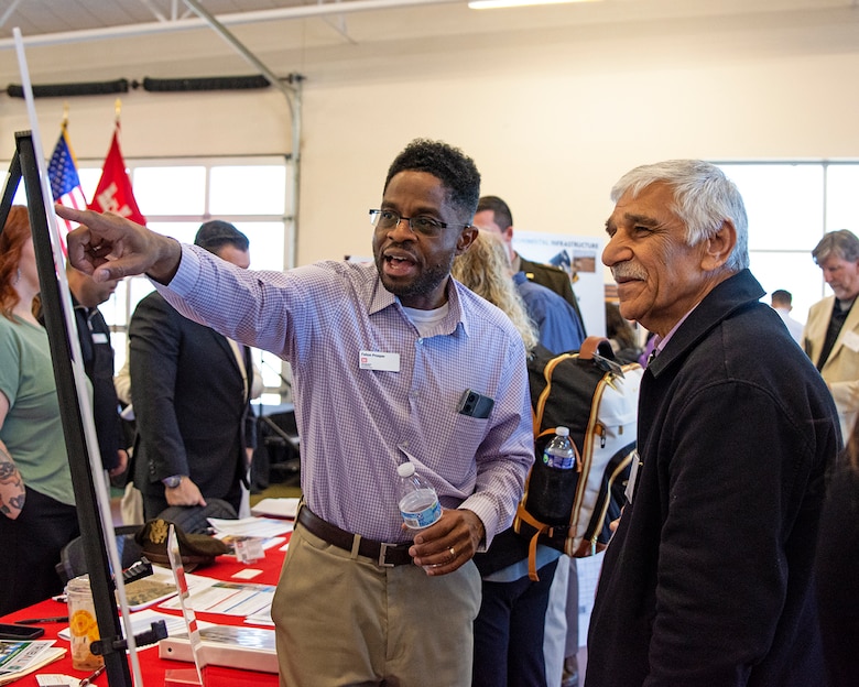 Felton Prosper (left), senior project manager, Civil Project Management Branch, USACE-Albuquerque District, shows upcoming business opportunities within the district to one of the attendees during the district’s Business Opportunities Open House at the Sid Cutter Pilot’s Pavilion at the Balloon Fiesta Park in Albuquerque, N.M., Feb. 20, 2025.