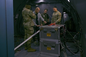 U.S. Air Force Airmen receive an overview of the KC-46 Roll-On Beyond Line-of-Sight Enhancement (ROBE) system during Bamboo Eagle 25-1 operations at Nellis Air Force Base, Nevada, Feb. 12, 2025. The ROBE system on the KC-46 provided Command and Control support for Bamboo Eagle 25-1. (U.S. Air Force photo by Senior Airman Makenna Patterson)