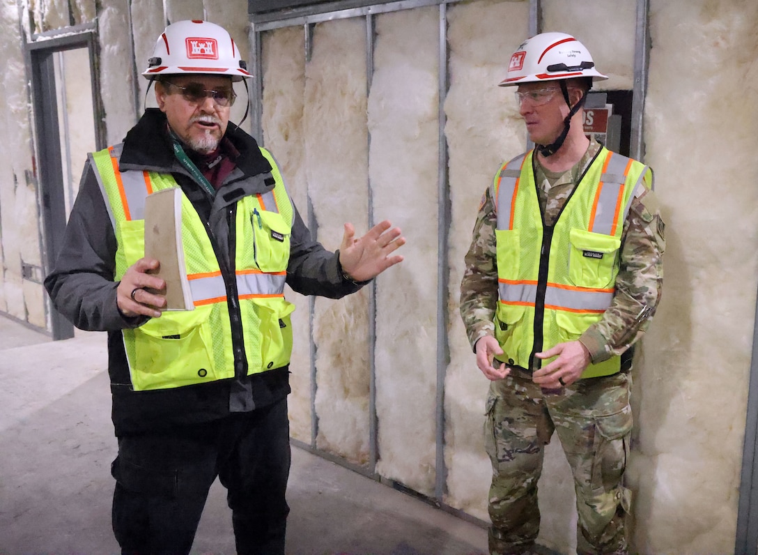 Two men standing in a renovates building.