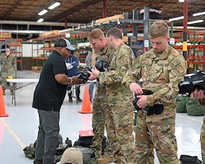 Deployers put on gas masks during combat readiness exercise.