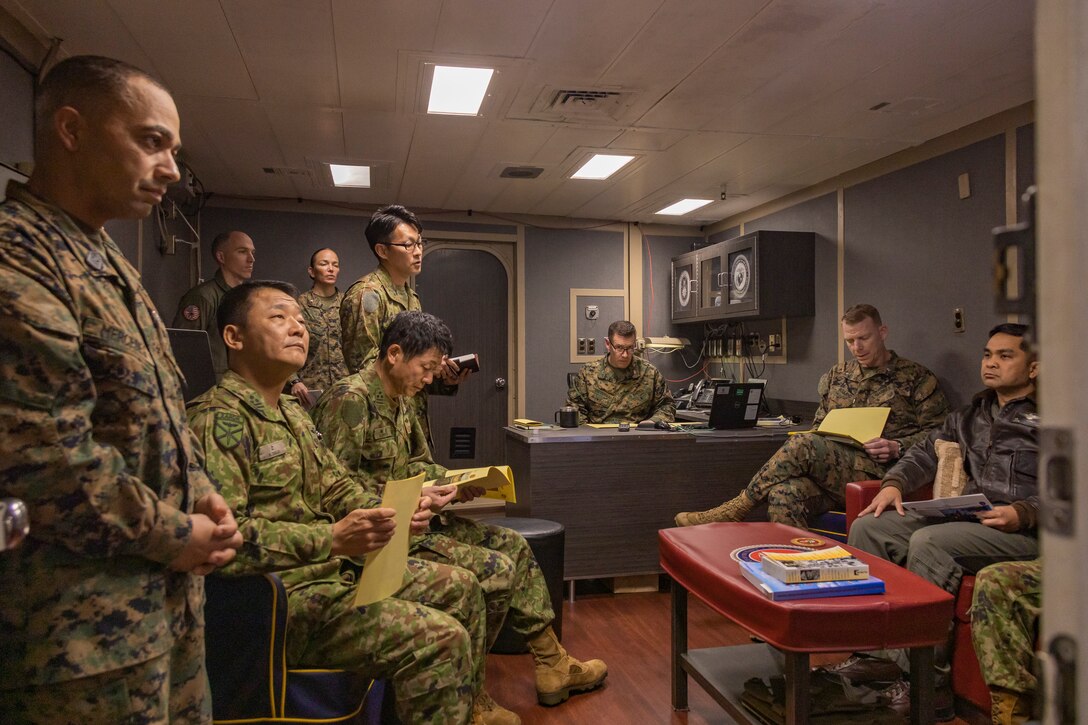 Members of the Japan Ground Self-Defense Force conduct a brief aboard the amphibious assault ship USS America (LHA 6) during a recent visit as LHA 6 conducts routine operations in the Philippine Sea, Japan, Feb. 3, 2025. The visit was part of a broader effort by the U.S. Marine Corps, U.S. Navy, JGSDF and Japan Maritime Self Defense Force to enhance their military cooperation and interoperability. The U.S.-Japan alliance plays a key role in the defense against potential aggressors. To support these efforts, the Amphibious Ready Group and Marine Expeditionary Unit and the ARDR regiments continue to invest in interactions aimed at areas of mission complementarity to reliably and more capably respond in tandem to a crisis. These exchanges will further strengthen the Marines’ and ARDR’s ability to work together more seamlessly and maintain a robust deterrence presence in the region. The ARG/MEU, which consists of more than 5,000 Marines and Sailors, is currently underway conducting routine operations in the U.S. 7th Fleet's area of operations. 7th Fleet is the U.S. Navy's largest forward-deployed numbered fleet and routinely interacts and operates with allies and partners to preserve a free and open Indo-Pacific region. (U.S. Marine Corps photo by Sgt. Tyler Andrews)