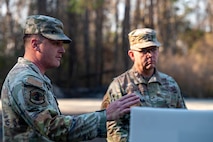 U.S. Air Force Staff Sgt. Tanner McClung, 628th Air Base Wing BATTLE school cadre, briefs Brig. Gen. Anthony Babcock, Air Mobility Command director of logistics, engineering and force protection, how BATTLE school trains Airmen for the future fight at Joint Base Charleston, South Carolina, Feb. 27, 2025.