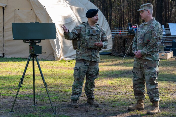 U.S. Air Force Tech. Sgt. Xavier Alvarez, 628th Security Forces Squadron counter-small unmanned aircraft system program manager, briefs Brig. Gen. Anthony Babcock, Air Mobility Command director of logistics, engineering and force protection at Joint Base Charleston, South Carolina, Feb. 27, 2025.