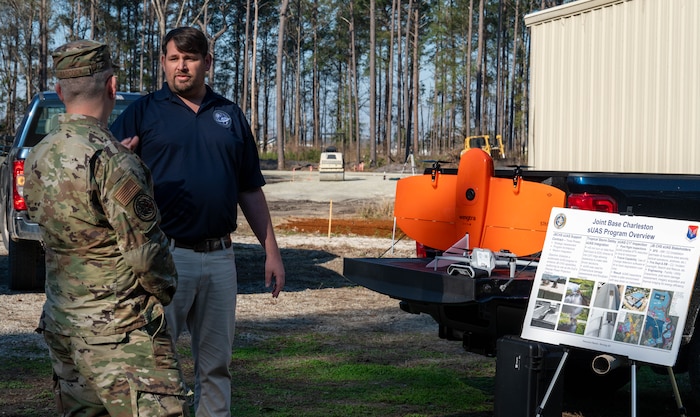 U.S. Air Force Brig. Gen. Anthony Babcock, Air Mobility Command director of logistics, engineering and force protection, listens to Chase Barron, 628th Air Base Wing small unmanned aircraft system program manager, on how the 628th ABW uses drones for damage assessment at Joint Base Charleston, South Carolina, Feb. 27, 2025.