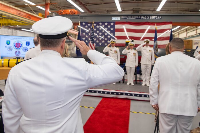 Rear Adm. Richard Seif, commander, Submarine Force, U.S. Pacific Fleet, is piped through sideboys during a change of command ceremony at Naval Base Kitsap-Keyport, Washington Sept. 25, 2023. During the ceremony, Capt. Jason Geddes, from Indianapolis, relieved Capt. Jason Weed as commander, Unmanned Undersea Vehicle Squadron (UUVRON) 1. (U.S. Navy photo by Mass Communication Specialist 2nd Class Victoria Galbraith)