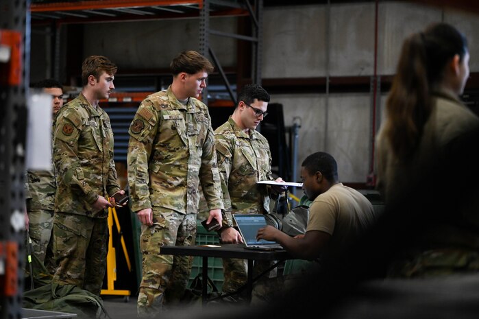 Airmen receive individual protective gear on the first day of BATTLE school.