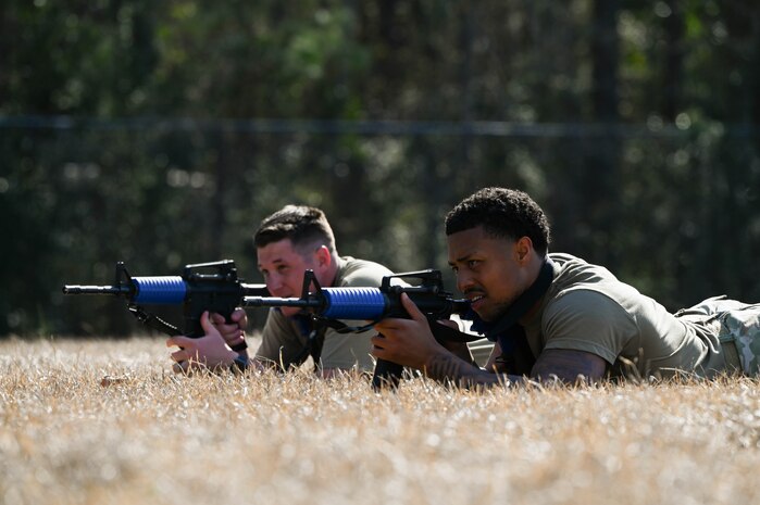 Two BATTLE school cadre demonstrate a defensive fighting position during BATTLE school.