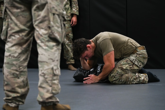 A survival, evasion, resistance and escape specialist demonstrate combative techniques during BATTLE school.
