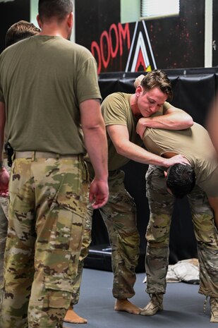 Airmen demonstrate combative techniques during BATTLE school.