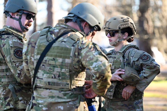 Airmen gear up in individual protective equipment during a field training exercise.
